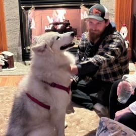 Lou the dog with adopters